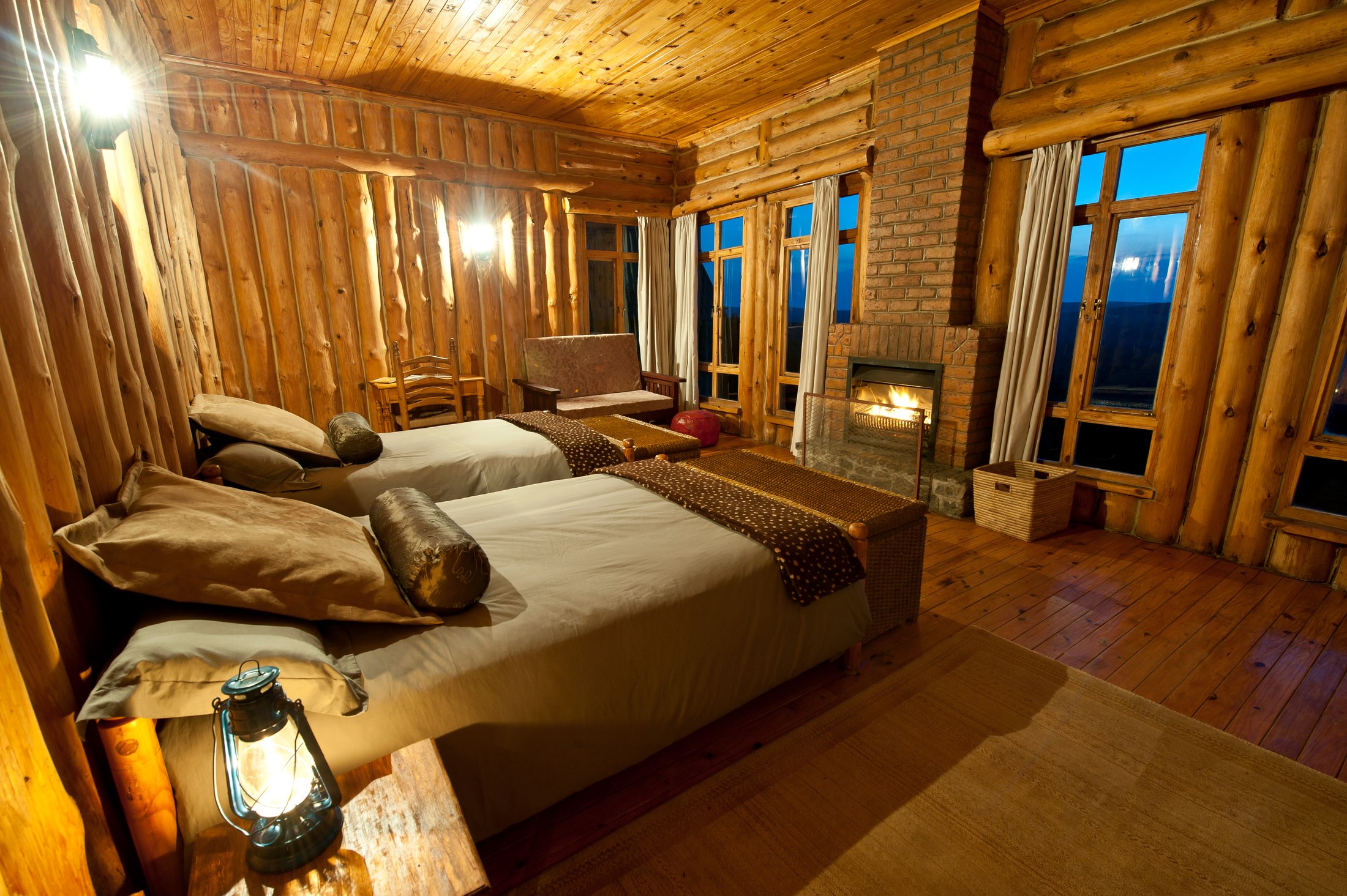 Beds and fireplace inside a Chelinda Lodge cabin.